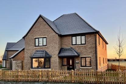 A large 5 bedroom home on a winters day with frost on the roof