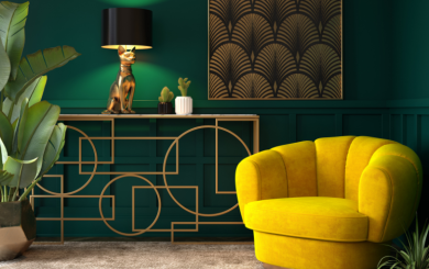 A tastefully decorated living room in deep greens with gold and mustard yellow features