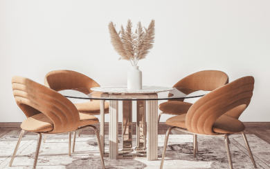 A minimal room with a glass dining table and trendy dining chairs 